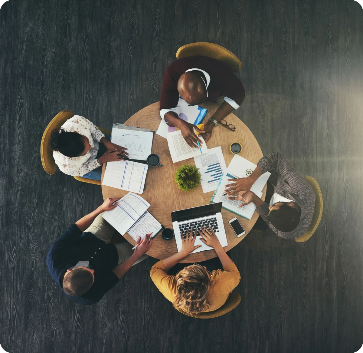 Team meeting around a circular table.